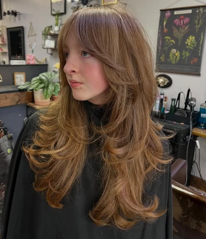 Long shag layered hairstyle with side swept bangs trendy modern look