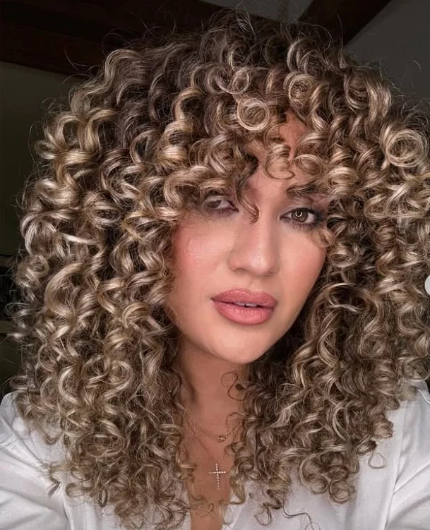 Loose curly hairstyle with side fringe relaxed natural style