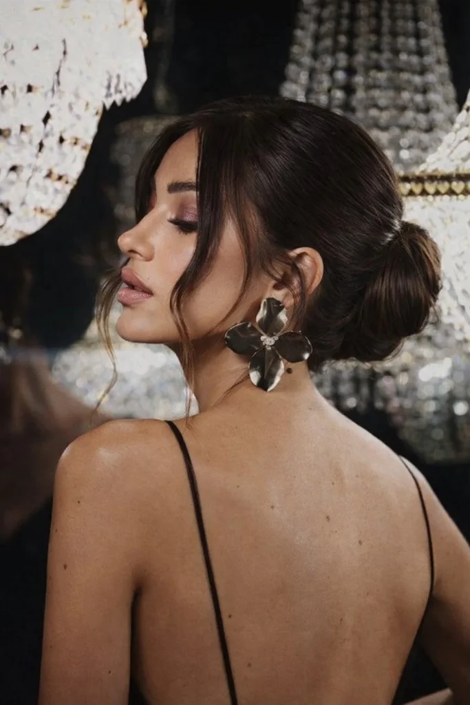 Low chignon hairstyle with side bangs timeless elegant style