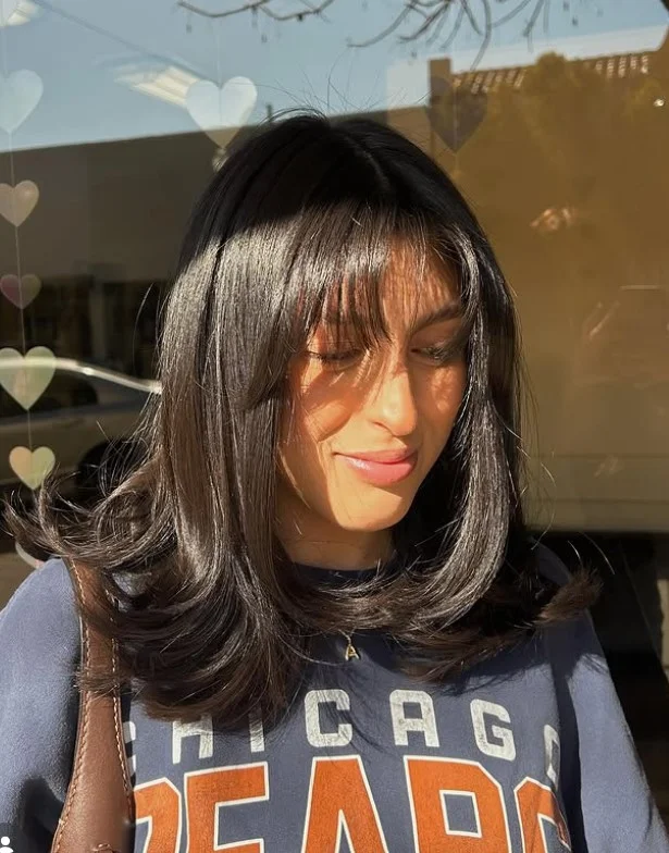 Medium layered hairstyle with bangs easy flattering look