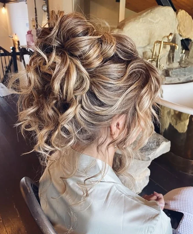 messy high bun beach hairstyle for long hair