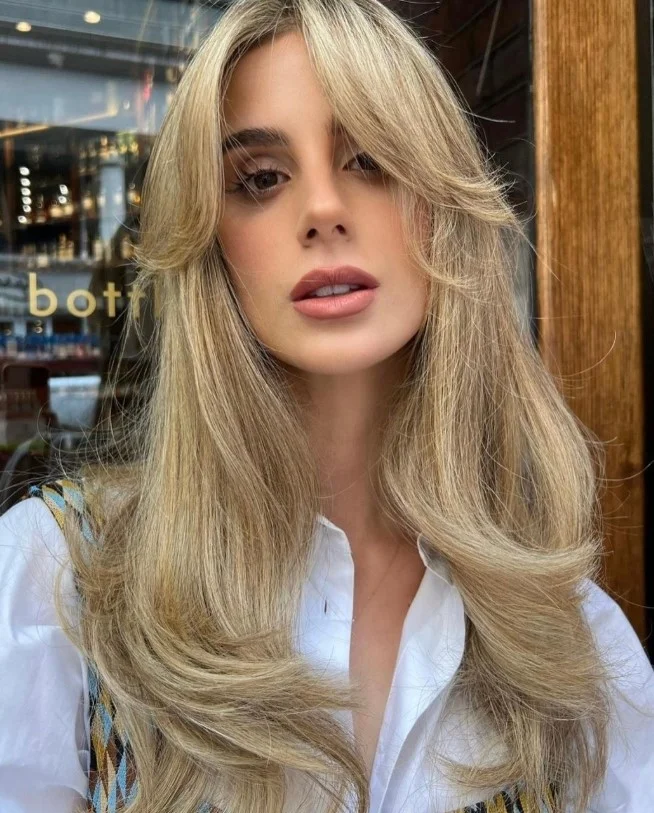 Modern curly hairstyle with side swept bangs stylish everyday look