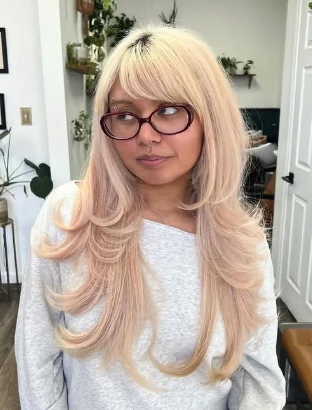 Modern long layered hairstyle with side bangs trendy everyday look