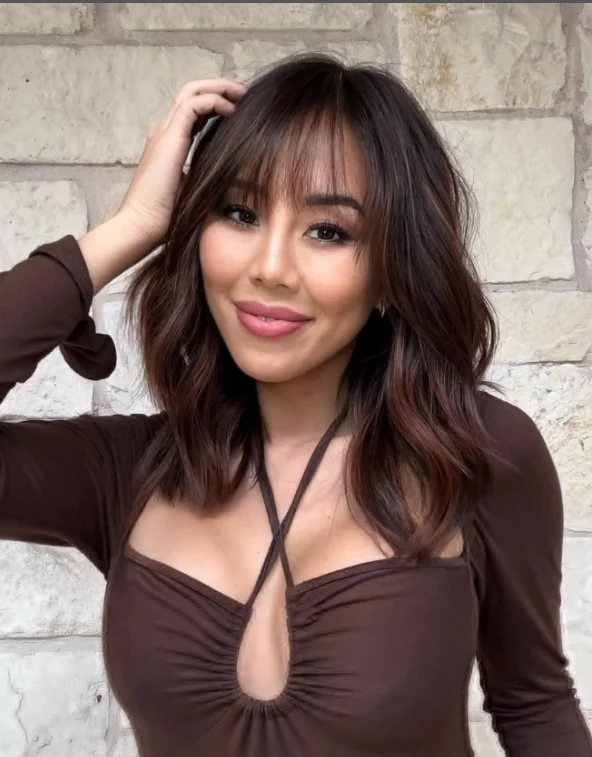 Modern mid length hairstyle with bangs trendy flattering look