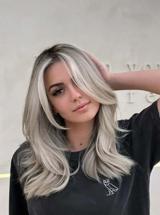 Platinum blonde hairstyle with side fringe bold modern style