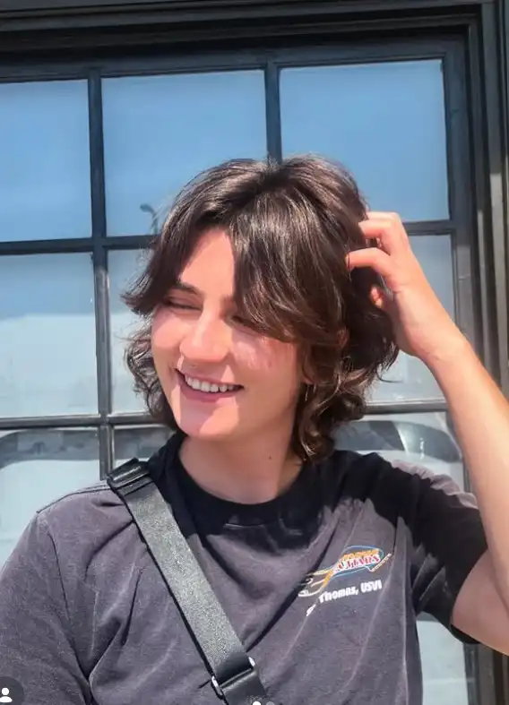 Short shag hairstyle with side swept bangs trendy textured look