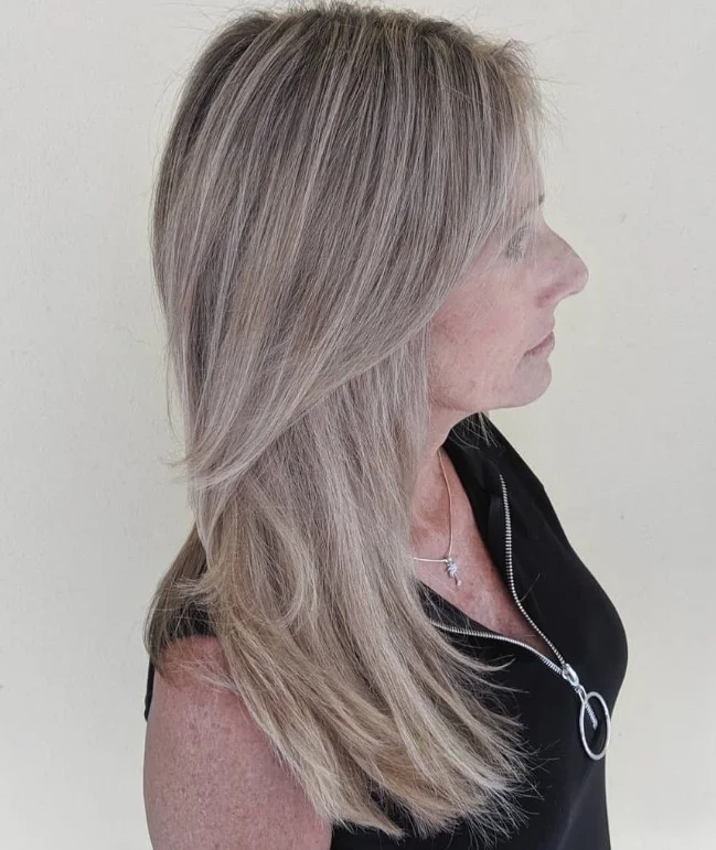 Sleek blonde hairstyle with side bangs polished smooth finish