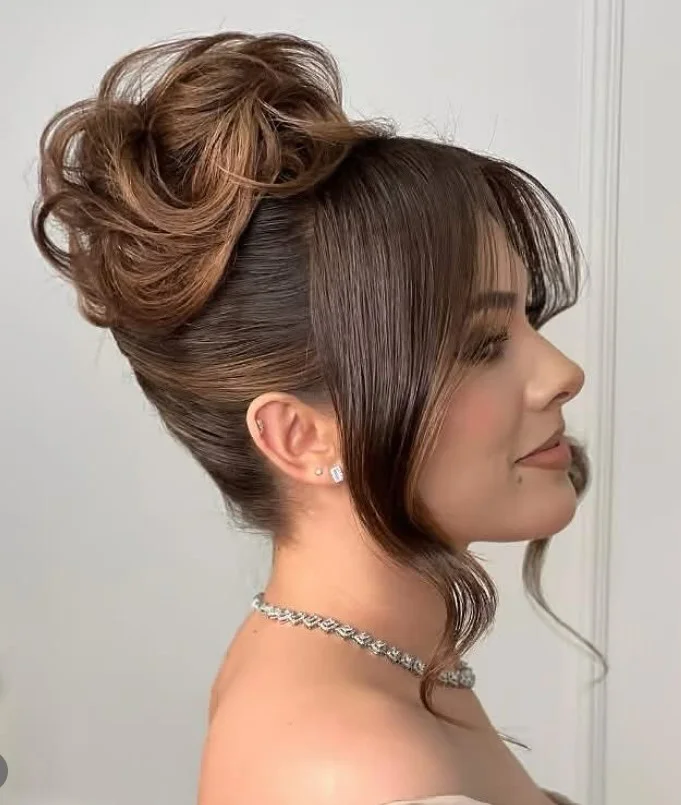 Sleek bun hairstyle with side bangs polished formal finish