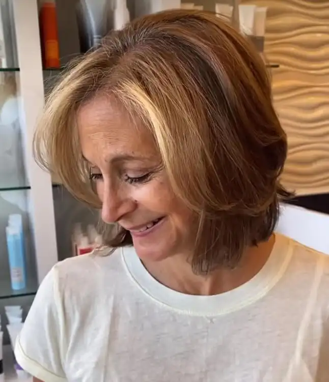 Sleek short hairstyle with side swept bangs smooth polished look