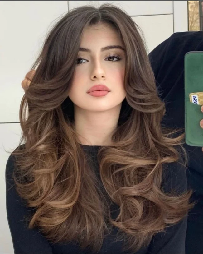 Soft curls with curtain bangs romantic hairstyle for long face