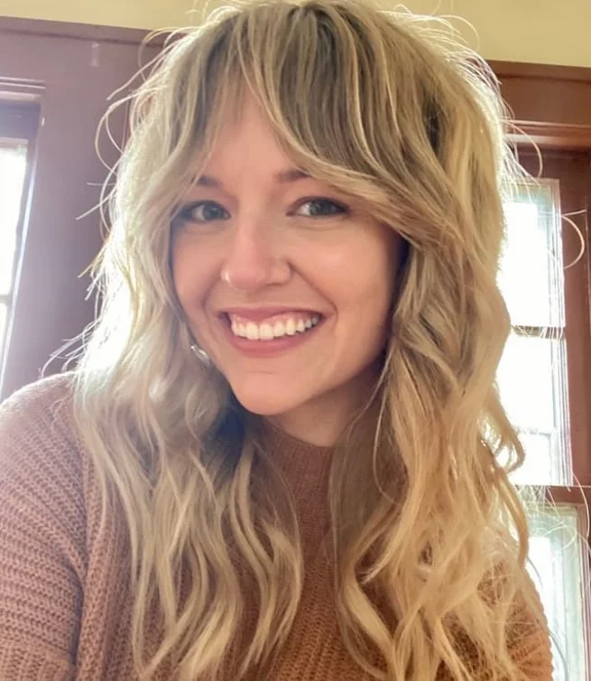 Tousled blonde hairstyle with side bangs relaxed natural style