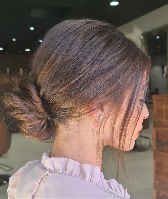 Twisted bun hairstyle with side bangs stylish neat finish