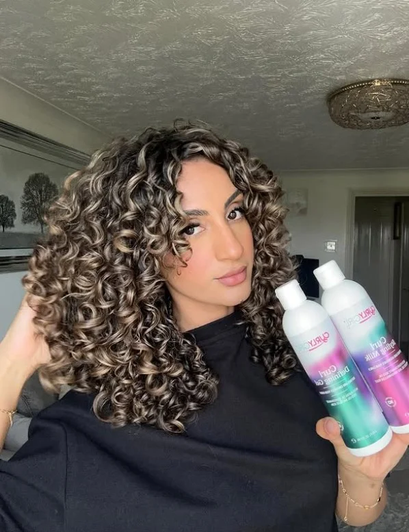 Voluminous curly hairstyle with side bangs full body texture look