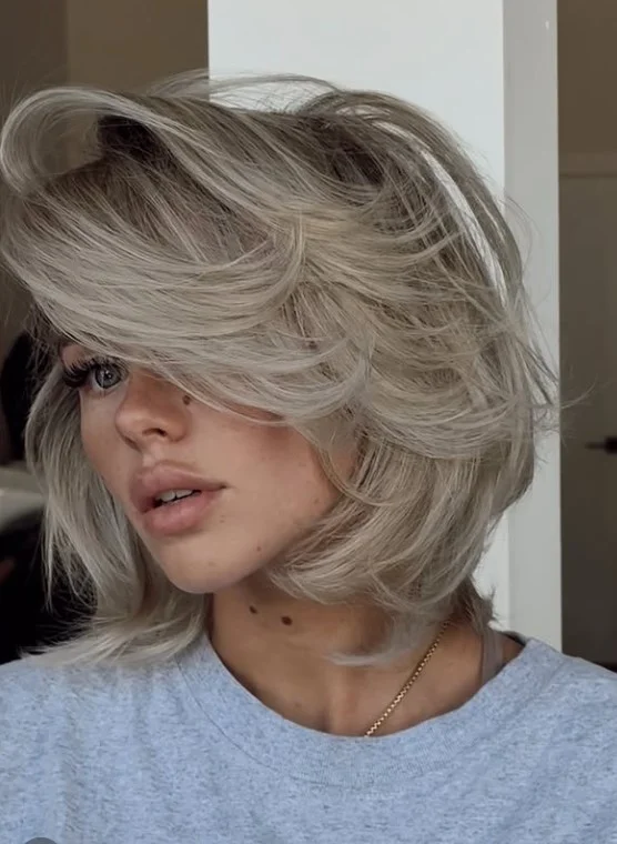 Voluminous layered bob hairstyle with side bangs full body style