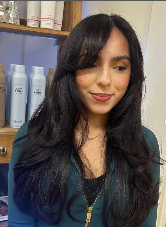 Voluminous long layered hairstyle with side bangs bouncy full style