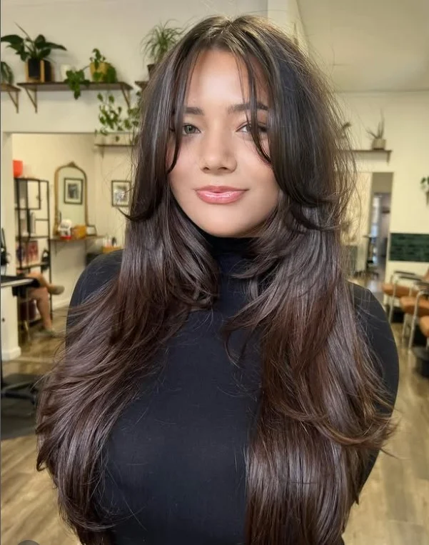 Wispy layered hairstyle with curtain bangs airy youthful style