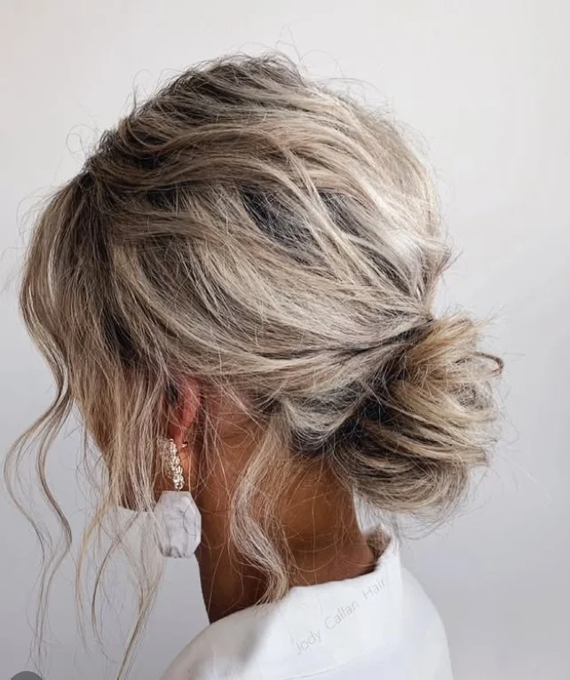 messy bridal beach bun hairstyle with textured waves