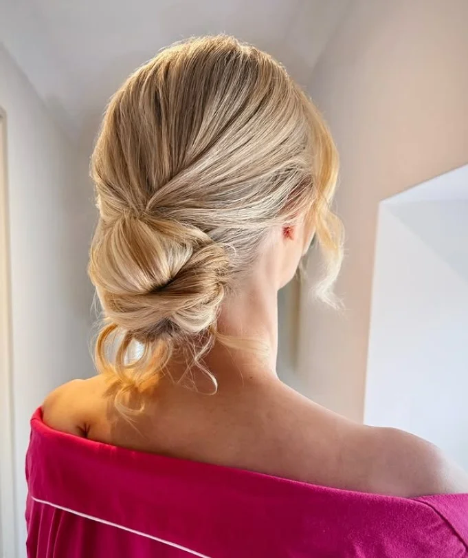 messy blonde beach bun hairstyle with textured hair