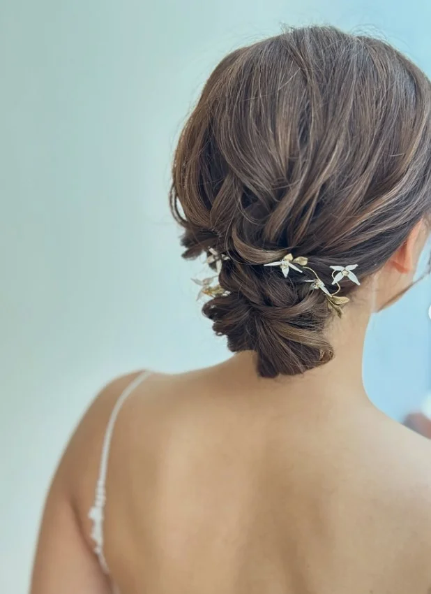 messy low beach bun hairstyle with soft loose strands
