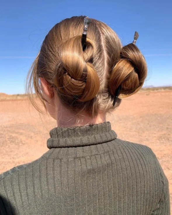 beachy space bun hairstyle with playful summer vibe