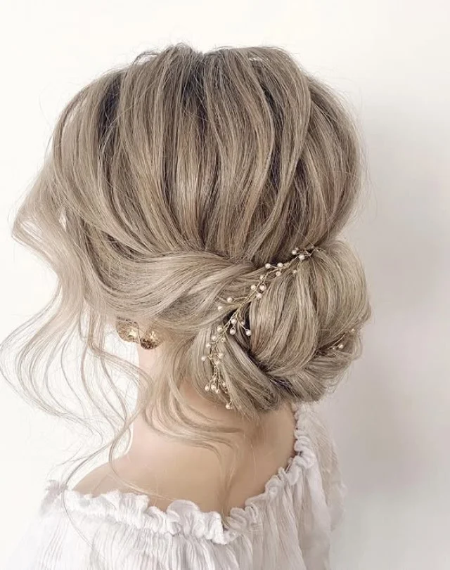 twisted low beach bun hairstyle elegant summer look