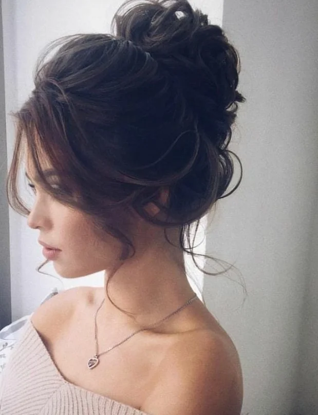 voluminous messy beach bun hairstyle with texture