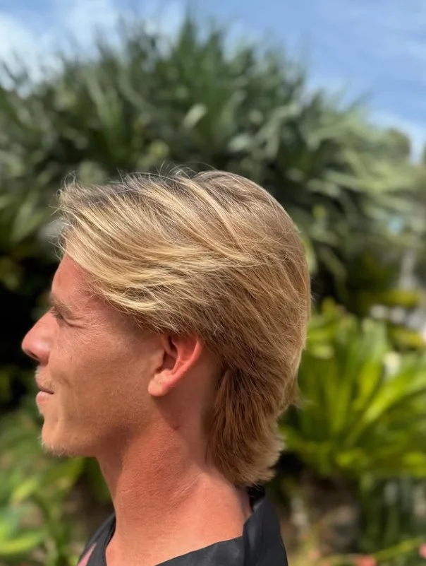 medium layered surfer haircut for guys beach look