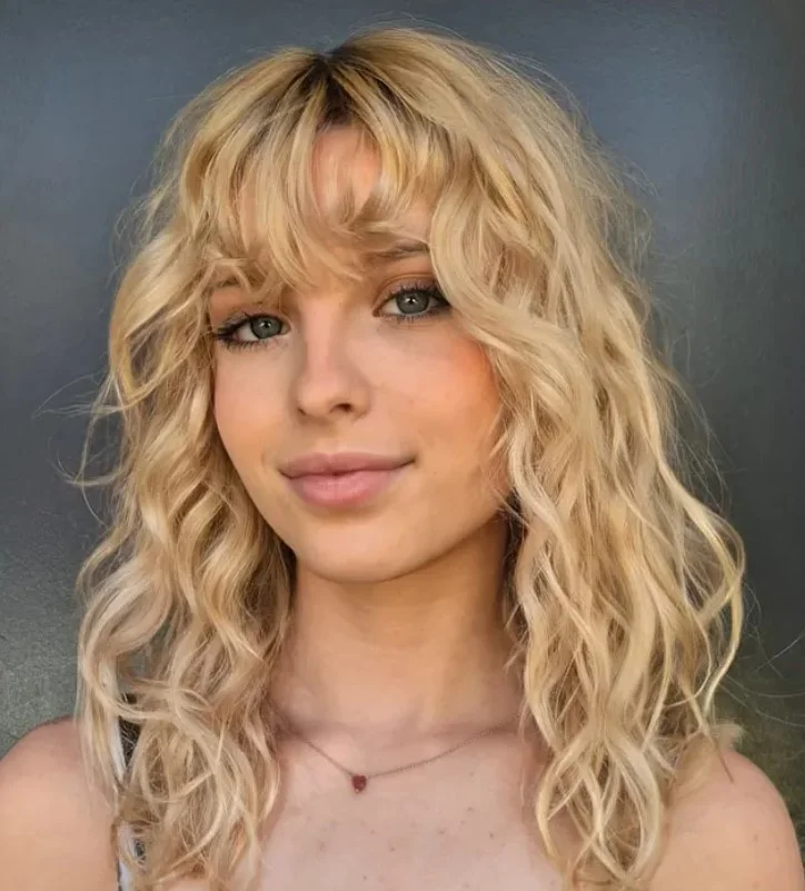 Beach waves hairstyle with soft bangs and natural movement