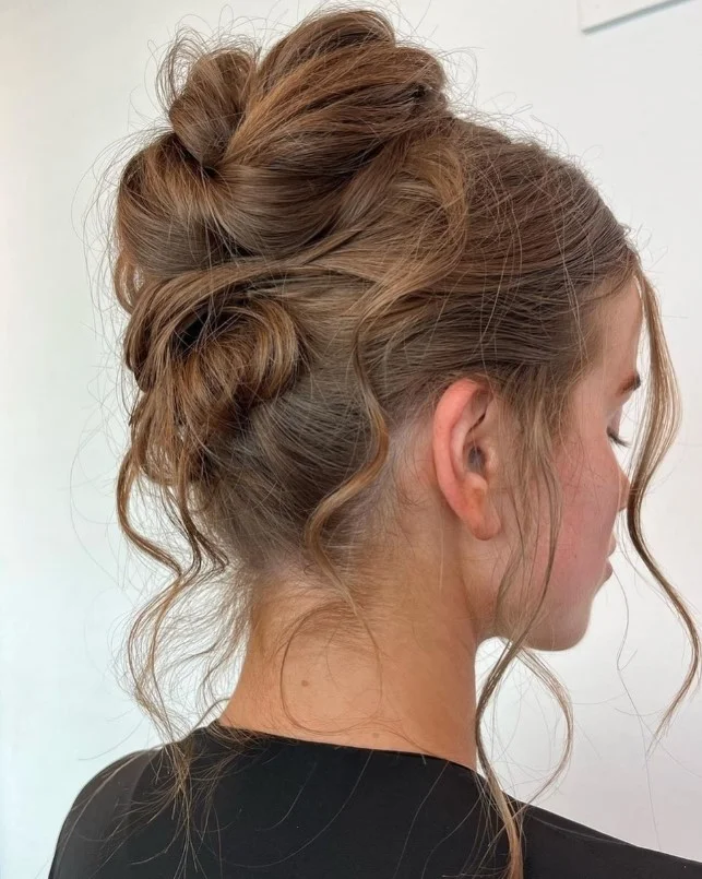Messy beach bun hairstyle for beach parties with effortless texture