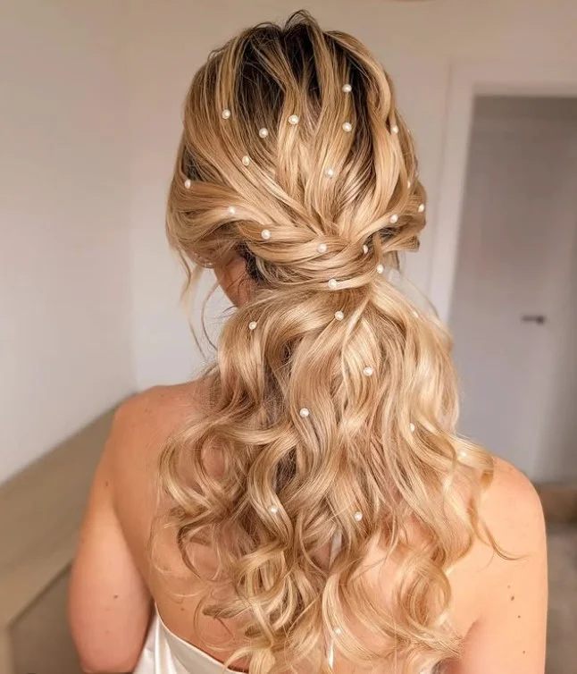 Beach hairstyle with pearl accessories and elegant summer texture