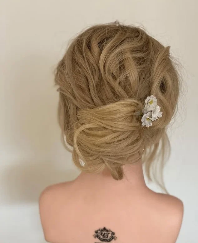 casual summer beach updo hairstyle with messy bun texture