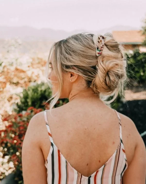 elegant ocean inspired updo hairstyle with soft beach waves