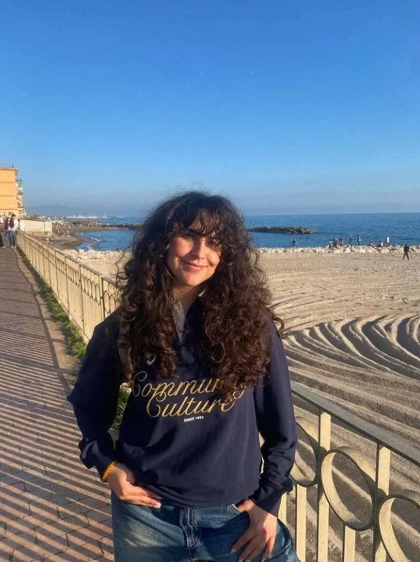 long curly beach hairstyle with soft beach bangs