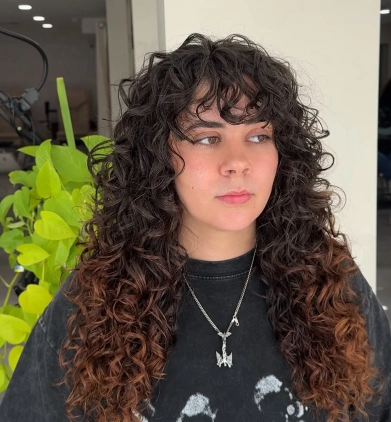 curly shag beach haircut for long curly hair women