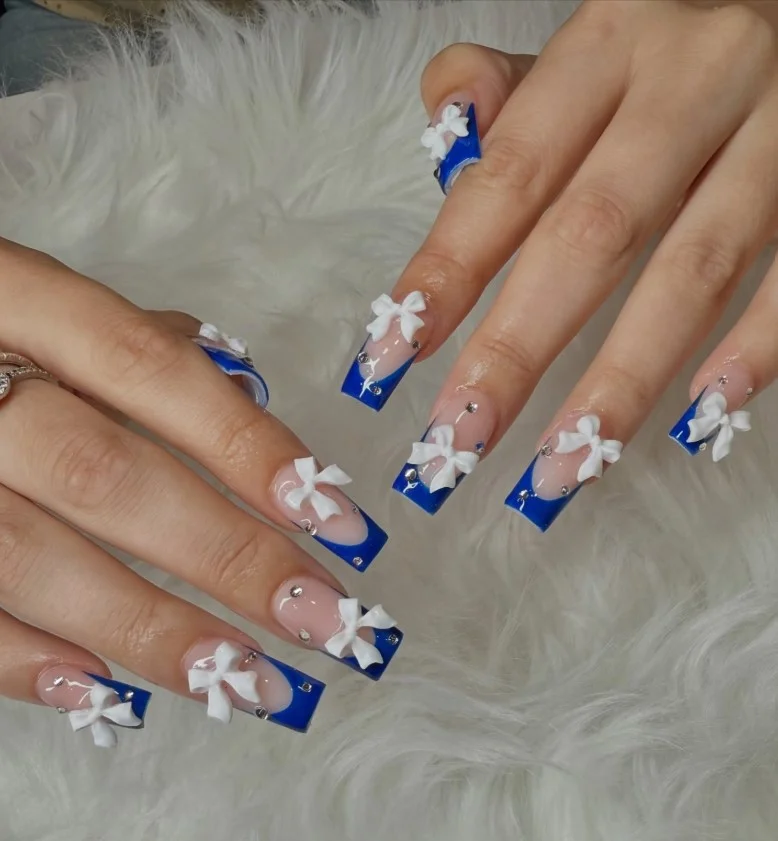 royal blue french tip nails with rhinestones glam look