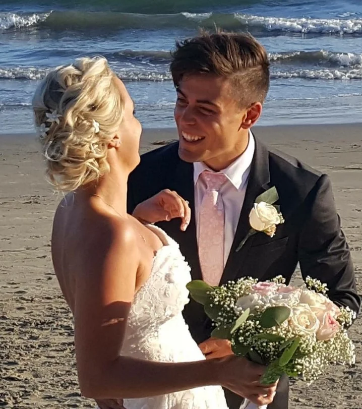 side swept beach updo hairstyle with glamorous soft curls
