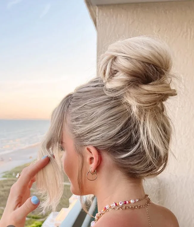 textured high beach bun hairstyle for summer hair