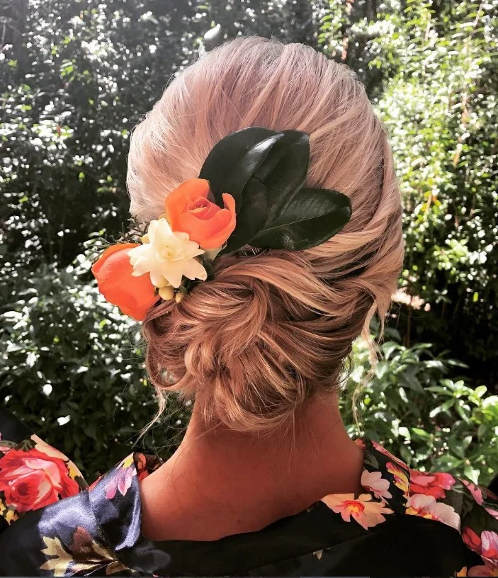 tropical flower beach updo hairstyle for vacation hair