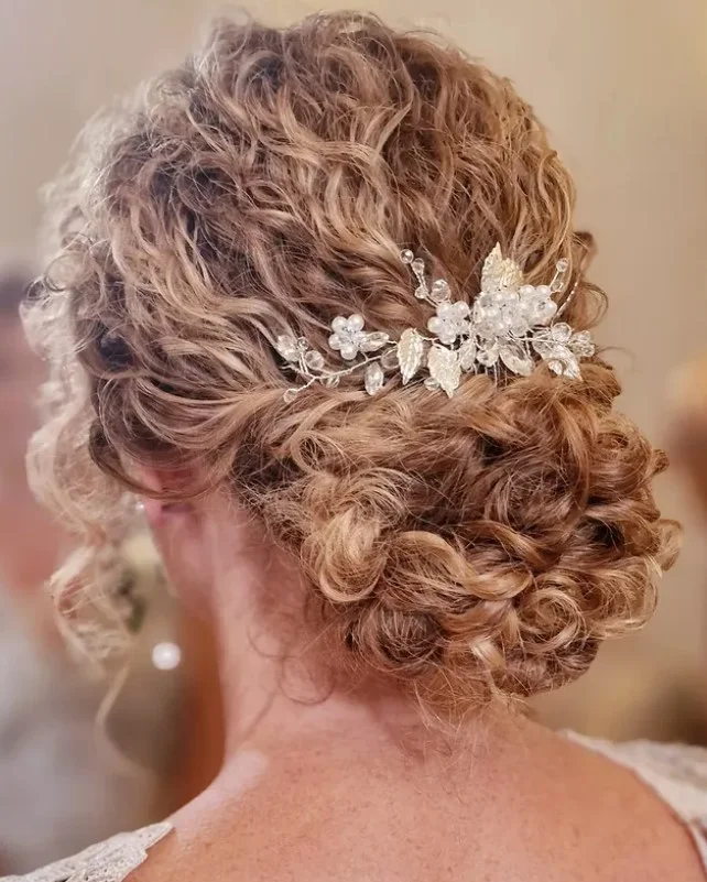 voluminous curly beach updo hairstyle with glamorous curls
