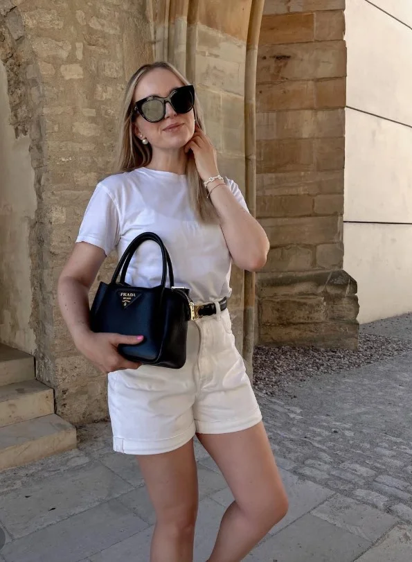 All-white shorts outfit with clean lines and minimalist summer fashion styling.