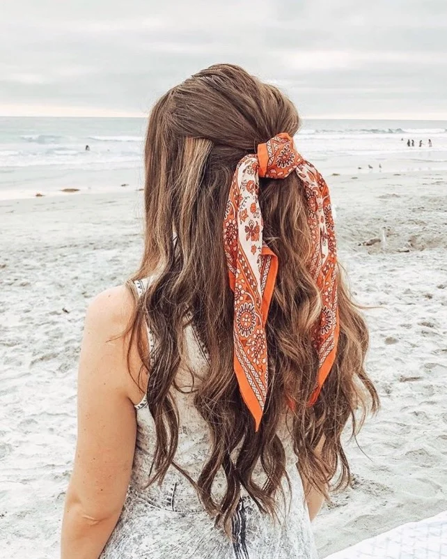 half up beach hairstyle for long hair with twisted summer detail