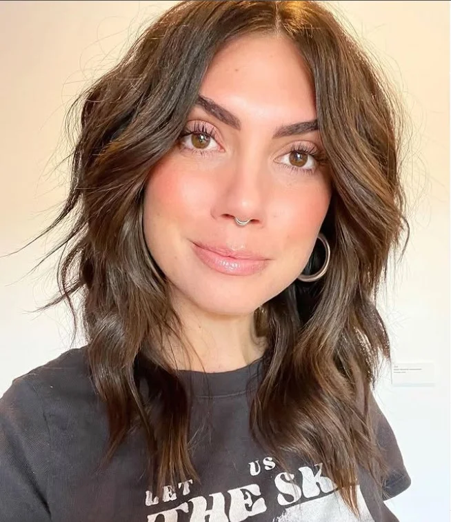 medium beach waves hairstyle with face framing layered haircut