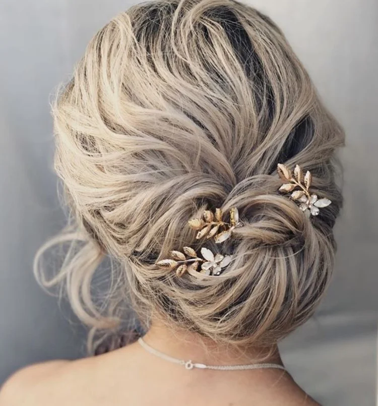 elegant low chignon bun hairstyle for seaside wedding guest