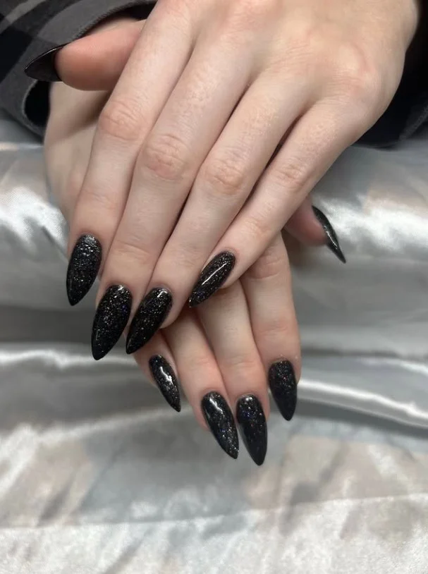 Black almond nails design with glitter accent nails sparkling party manicure style