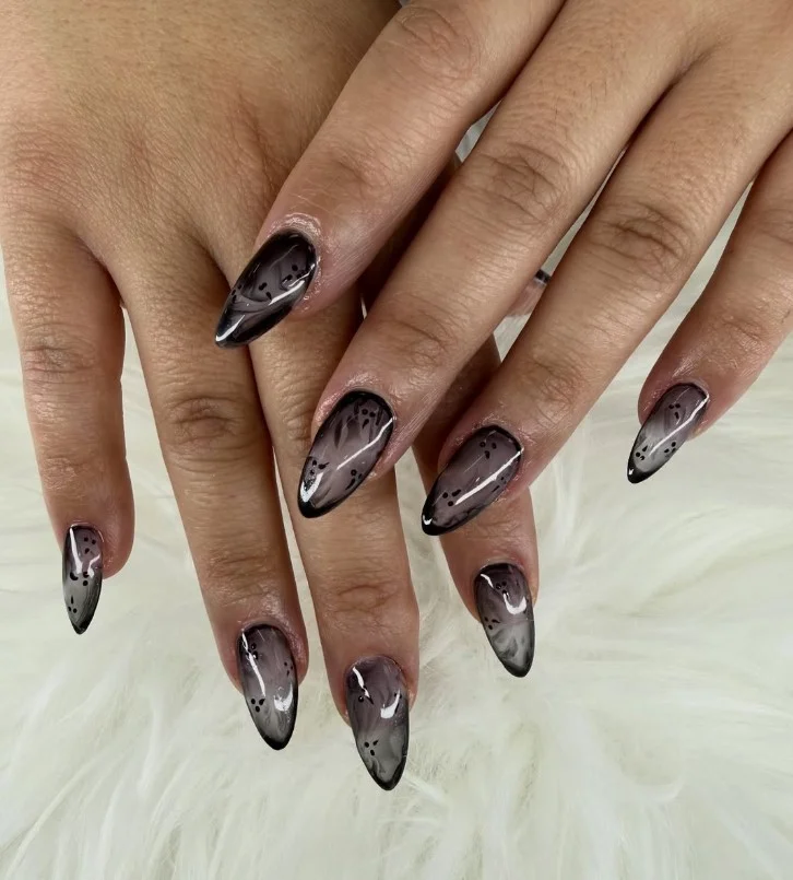 Black marble almond nails design artistic swirl effect luxury nail art inspiration