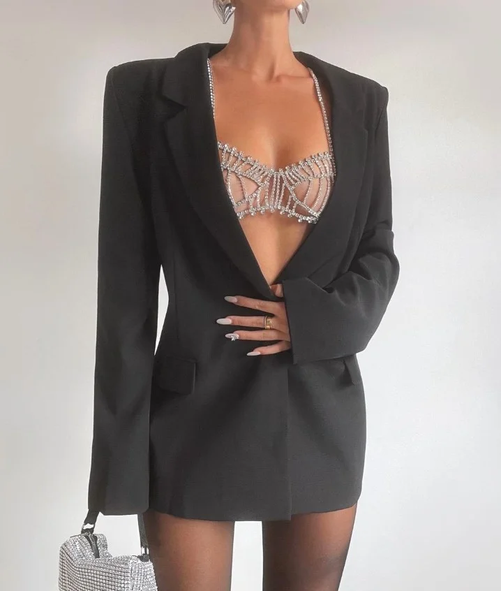 Neutral lace bralette layered under an oversized blazer with tailored pants.