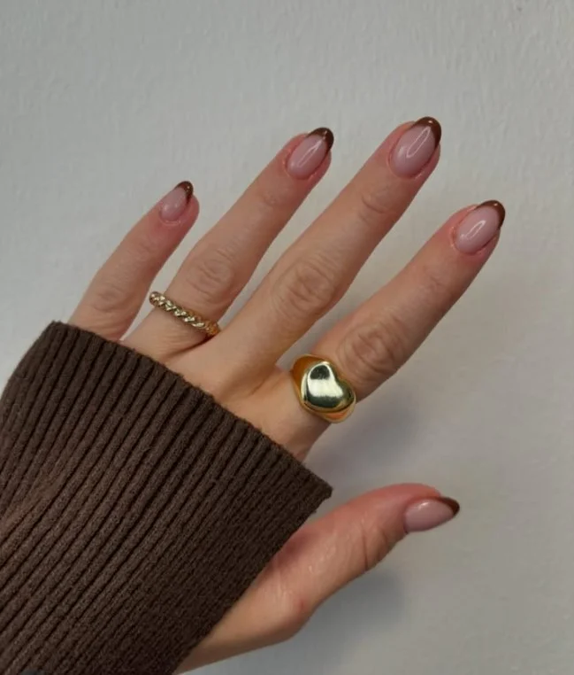 Short almond nails with thin brown micro French tip clean minimal design
