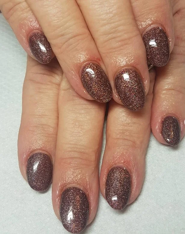 Brown almond nails with tiny sparkle accent subtle shiny elegant manicure