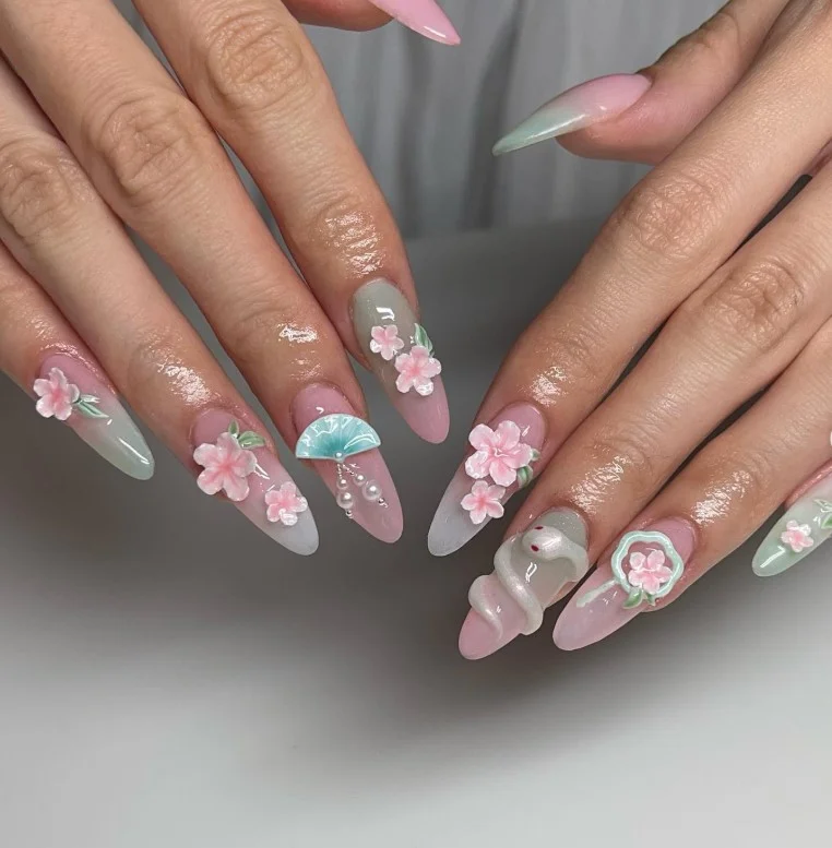 Soft cherry blossom summer 3D nail designs on a sheer pink manicure.