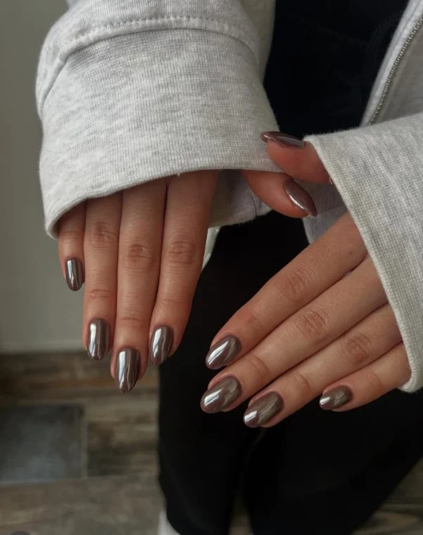 Rich chocolate brown almond nails with shiny gloss and soft salon finish.